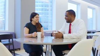 Aisha and businessman coffee chatting 