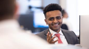 Josh Feyissa mid conversation while at desk