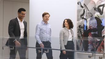Taylor Denara Walking through office with colleagues