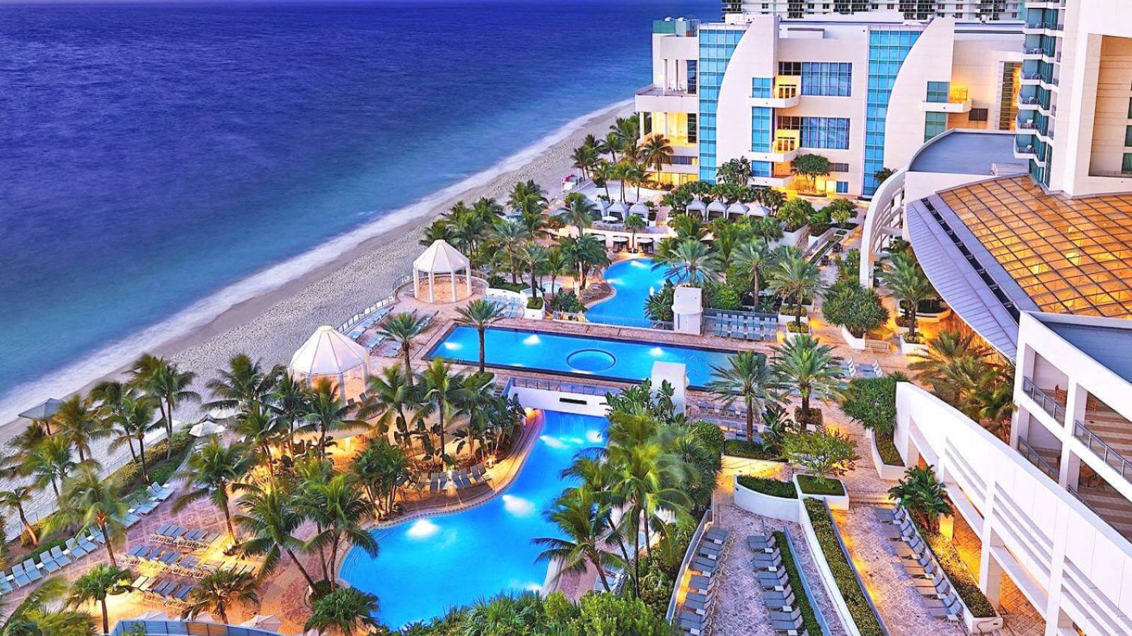 Beach and series of swimming pools at Florida resort hotel