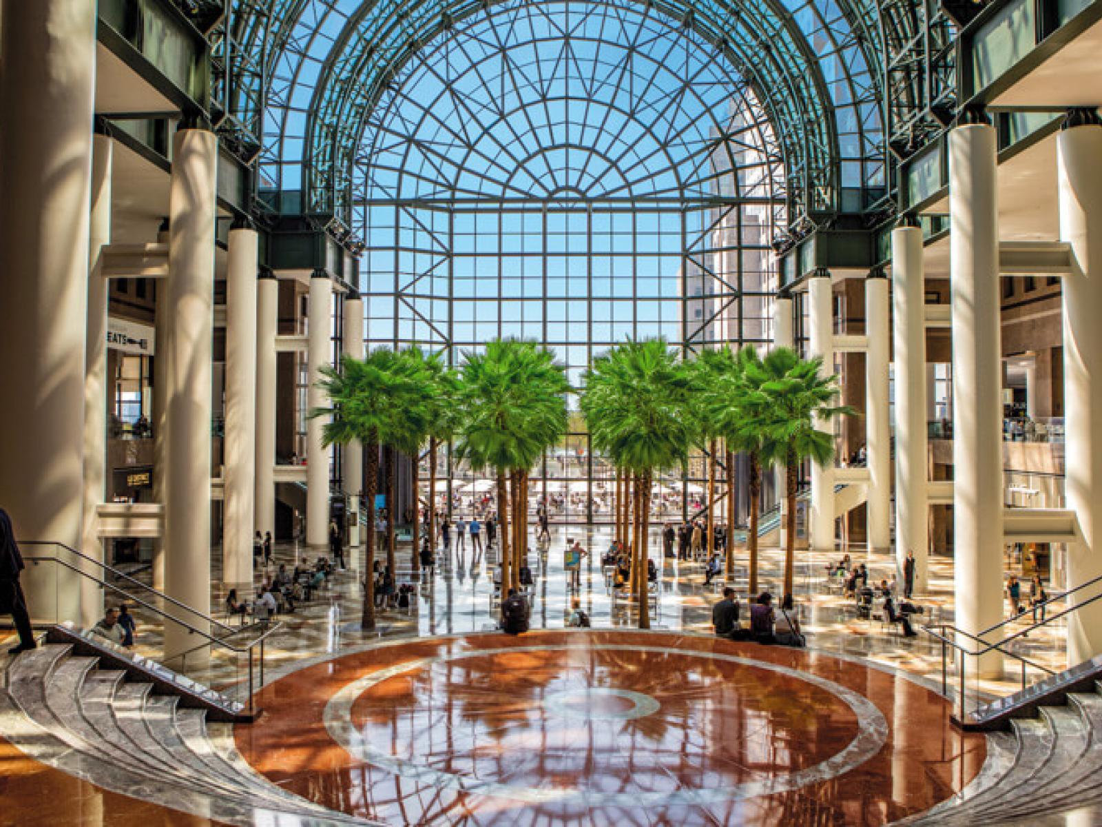Winter Garden, Brookfield Place, NYC Trees, glass atrium windows and coral-colored marble floors in the Winter Garden