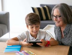 Grandson and grandmother at a table