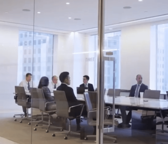 View of people sitting at a conference table