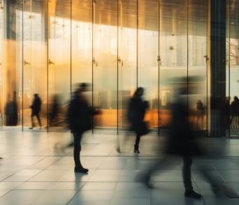 Motion-blurred people walking during rush hour