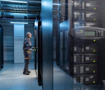 man working in a data center interior