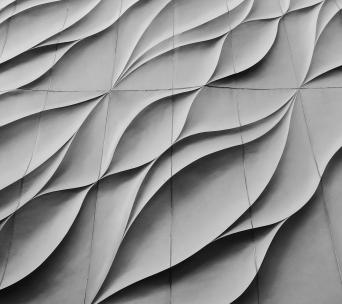 Architectural facade with wavy concrete panels in flowing design