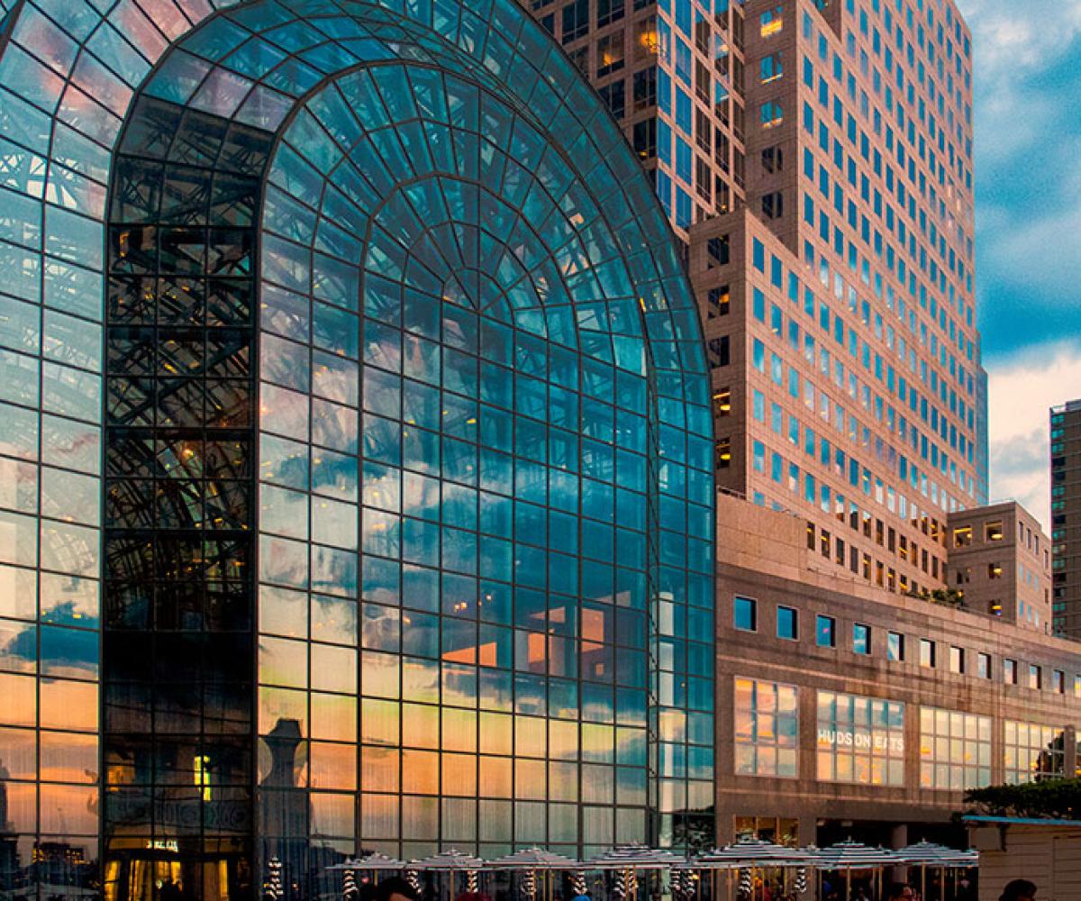 Sunset reflected in vaulted three-story windows of the Winter Garden