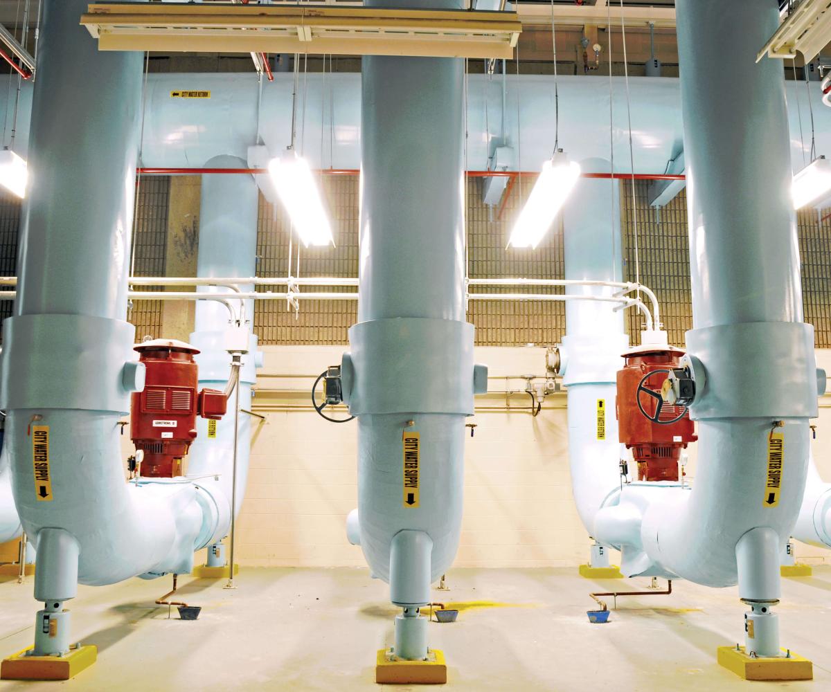 Array of massive white cooling pipes and red pumps